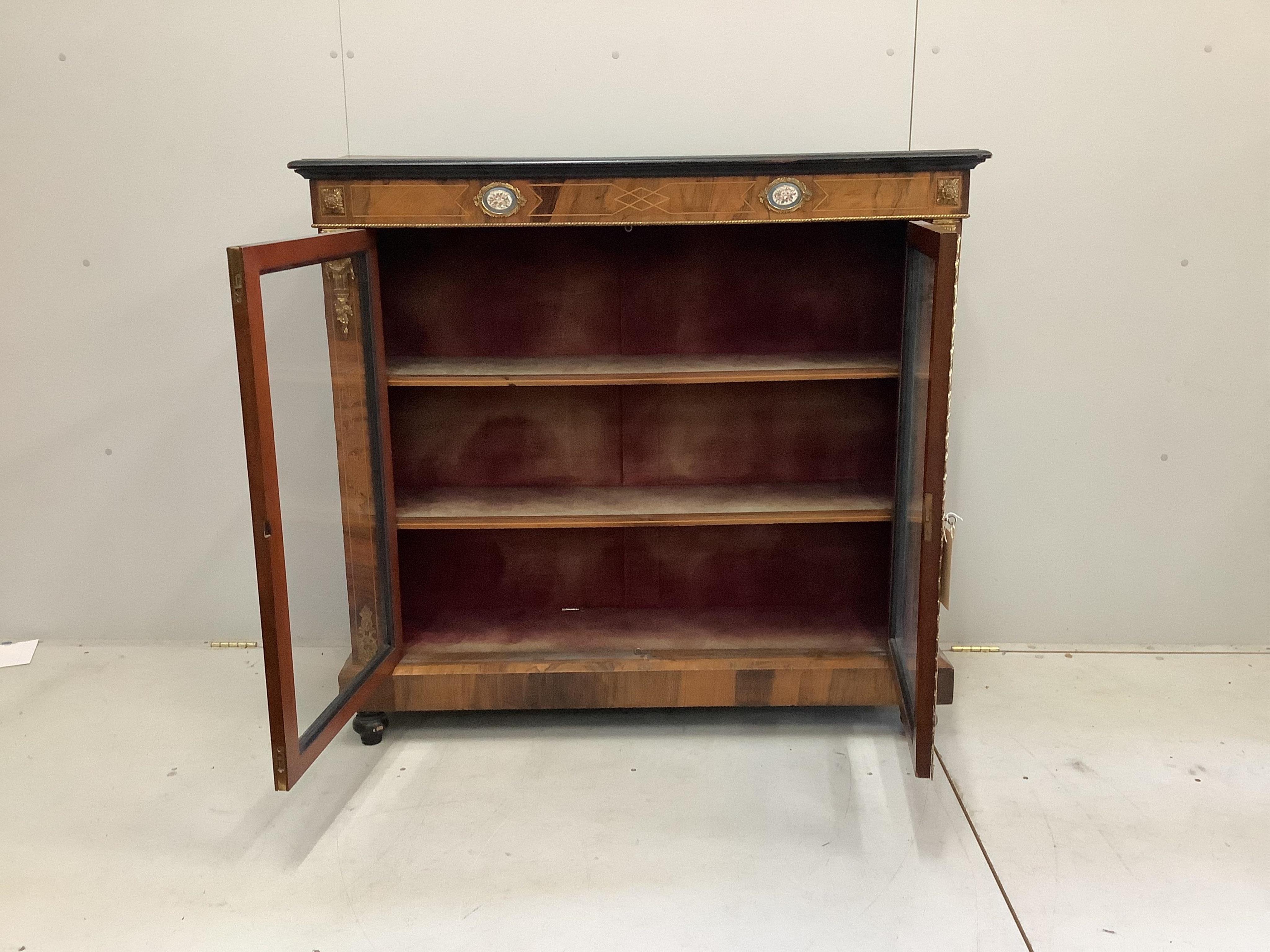 A late 19th century porcelain and gilt metal mounted walnut pier cabinet, width 120cm, depth 37cm, height 112cm. Condition - fair